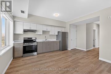 Woodstock (Woodstock - South) apartment for rent - A spacious kitchen with white cabinets and stainless steel appliances.