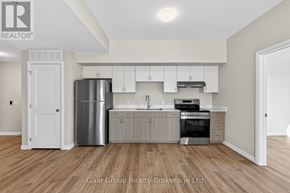 Woodstock (Woodstock - South) apartment for rent - A modern kitchen with white cabinets and stainless steel appliances.