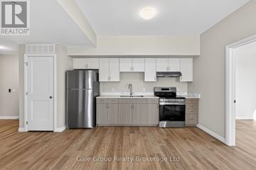 Woodstock (Woodstock - South) apartment for rent - A modern kitchen with white cabinets and stainless steel appliances.