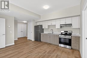 Woodstock (Woodstock - South) apartment for rent - A kitchen with white cabinets and a stainless steel refrigerator.