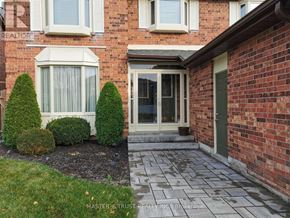 Markham (Markham Village) apartment for rent - A brick house with a green door and a glass window.