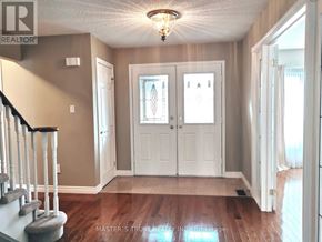 Markham (Markham Village) apartment for rent - A hallway with a staircase and a chandelier.