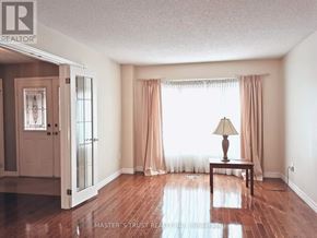 Markham (Markham Village) apartment for rent - A room with a wooden floor and a lamp on a table.