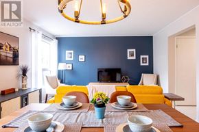 Kitchener apartment for rent - A dining room with a table set for two and a yellow couch.