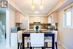 Kitchener apartment for rent - A kitchen with a dining table and chairs.