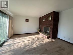 Windsor apartment for rent - A room with a fireplace and a window with curtains.