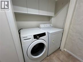 Windsor apartment for rent - A white Samsung washing machine in a small laundry room.