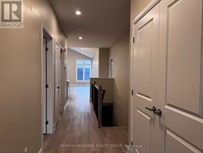 Brockville apartment for rent - A hallway with white doors and a wooden floor.
