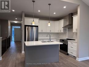 Brockville apartment for rent - A modern kitchen with a large island and stainless steel appliances.