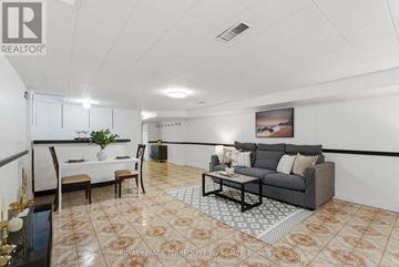 Toronto (Palmerston-Little Italy) apartment for rent - A living room with a grey couch, a coffee table, and a painting on the wall.