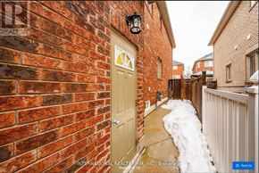Richmond Hill (Westbrook) apartment for rent - A red brick wall with a white door and a black lantern above it.
