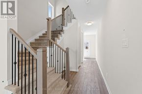 Ottawa townhouse for rent - A staircase with a black railing and wooden steps.