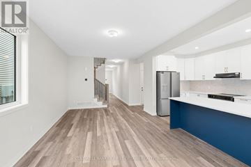 Ottawa townhouse for rent - A spacious kitchen with white cabinets and a blue accent wall.