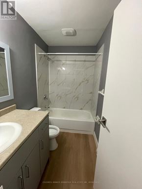 Welland (Lincoln/Crowland) multi-family for rent - A bathroom with a marble shower and a white bathtub.
