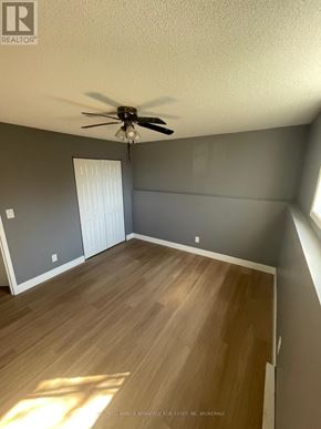Welland (Lincoln/Crowland) multi-family for rent - A room with a ceiling fan and wooden flooring.
