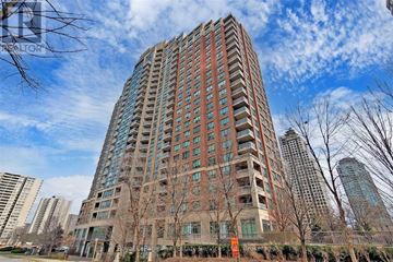 Mississauga (City Centre) condo for rent - A tall residential building with many windows and balconies.