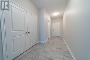 Thorold (Hurricane/Merrittville) apartment for rent - A hallway with white doors and carpeted flooring.