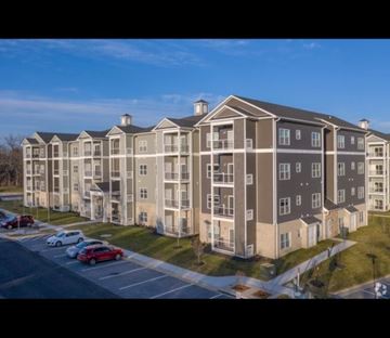 Winchester apartment for rent - A large apartment complex with a parking lot in front.