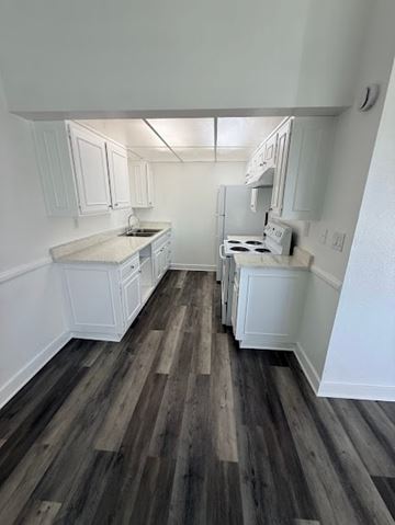 Anaheim apartment for rent - A kitchen with white cabinets and a wood floor.