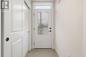 London North (North A) townhouse for rent - A white door with a window above it in a room.