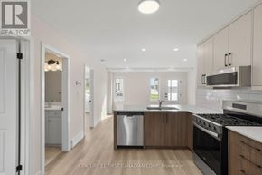 London North (North A) townhouse for rent - A modern kitchen with wooden cabinets and stainless steel appliances.