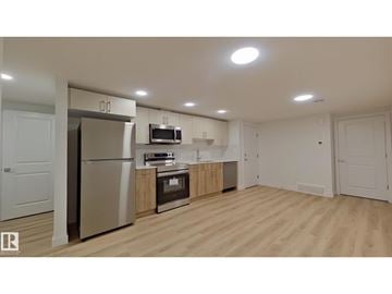 Edmonton apartment for rent - A kitchen with wooden floors and white walls.