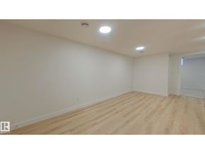 Edmonton apartment for rent - A room with wooden flooring and white walls.