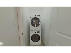 Edmonton apartment for rent - A white washing machine and dryer in a small laundry room.