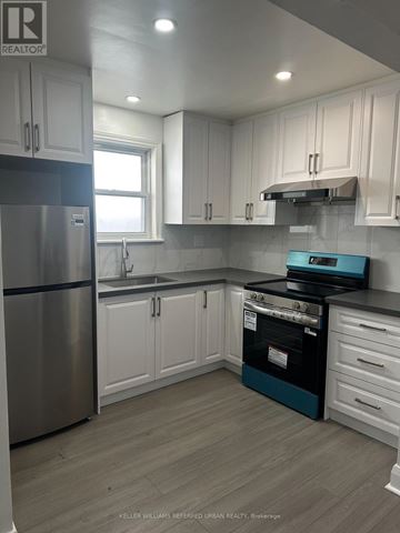 Toronto (Woodbine-Lumsden) apartment for rent - A kitchen with white cabinets and a stainless steel refrigerator.