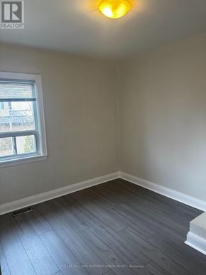 Toronto (Woodbine-Lumsden) apartment for rent - A room with a window and a wooden floor.
