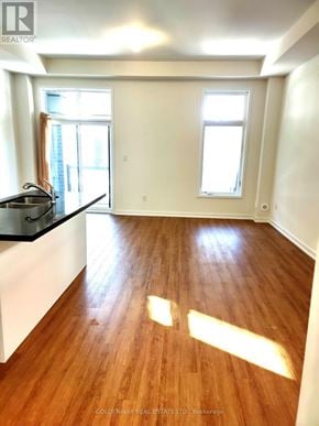 Markham (Wismer) townhouse for rent - A room with wooden floors and white walls.