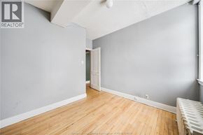 Windsor apartment for rent - A room with wooden flooring and a white door.