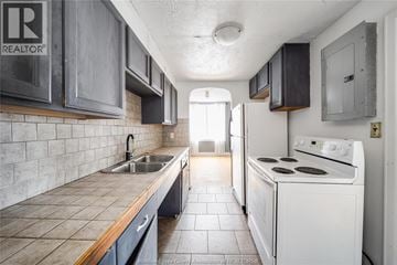 Windsor apartment for rent - A kitchen with a white stove and a sink.