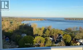 Ottawa condo for rent - A real estate company logo is displayed on a screen showing a scenic view of a residential area with houses and a body of water.