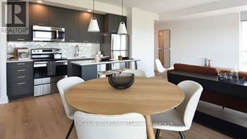 Ottawa condo for rent - A modern kitchen with a wooden table and white chairs.