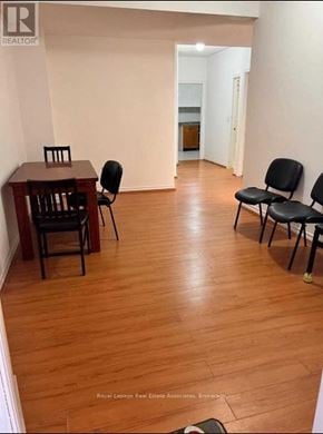 Markham (Victoria Square) apartment for rent - A room with a wooden floor and a table with chairs.