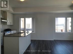 Toronto (New Toronto) townhouse for rent - A kitchen with a sink and a window.