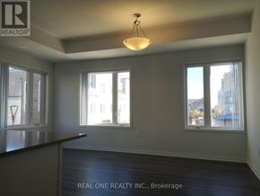 Toronto (New Toronto) townhouse for rent - A room with a black countertop and a large window overlooking a cityscape.