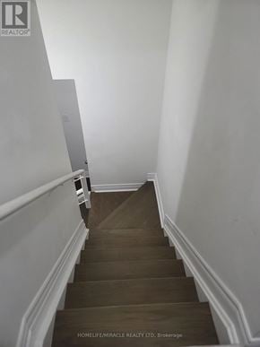 Clarington (Bowmanville) apartment for rent - A staircase with a wooden floor and white walls.