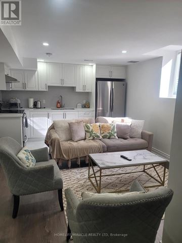 Clarington (Bowmanville) apartment for rent - A living room with a grey couch and a coffee table.
