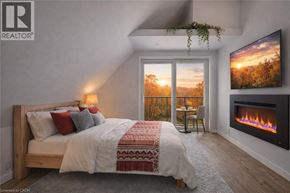 Brantford apartment for rent - A bedroom with a large bed and a fireplace.