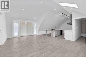 Brantford apartment for rent - A spacious, well-lit room with a kitchen area and a dining table.
