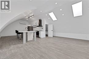 Brantford apartment for rent - A spacious room with a desk and a kitchenette.