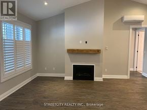 Southwest Middlesex (Wardsville) fourplex for rent - A room with a fireplace and wooden floors.