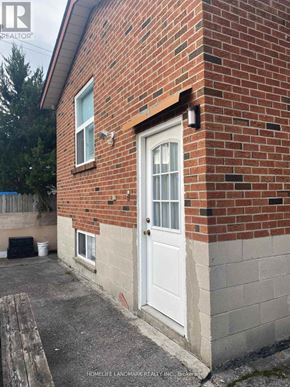 Toronto (Oakwood Village) apartment for rent - A brick house with a white door and a small porch.