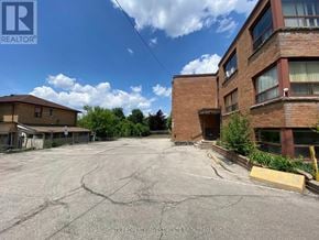 Brampton (Brampton East) multi-family for rent - A parking lot with a building in the background and a sign that says "REALTOR".