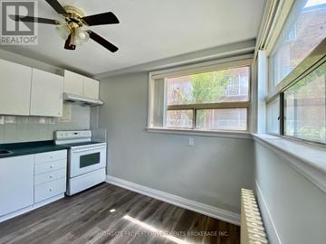 Brampton (Brampton East) multi-family for rent - A well-lit kitchen with a fan and a window.