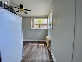 Brampton (Brampton East) multi-family for rent - A room with a ceiling fan and a window with a view of trees.