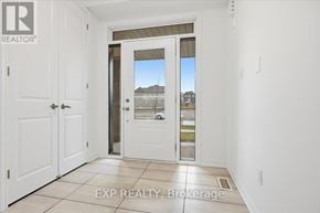 Cobourg apartment for rent - A white door with a glass window is in a room with white walls.