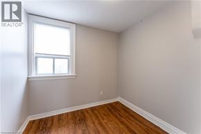 Hamilton townhouse for rent - A room with a window and wooden floors.